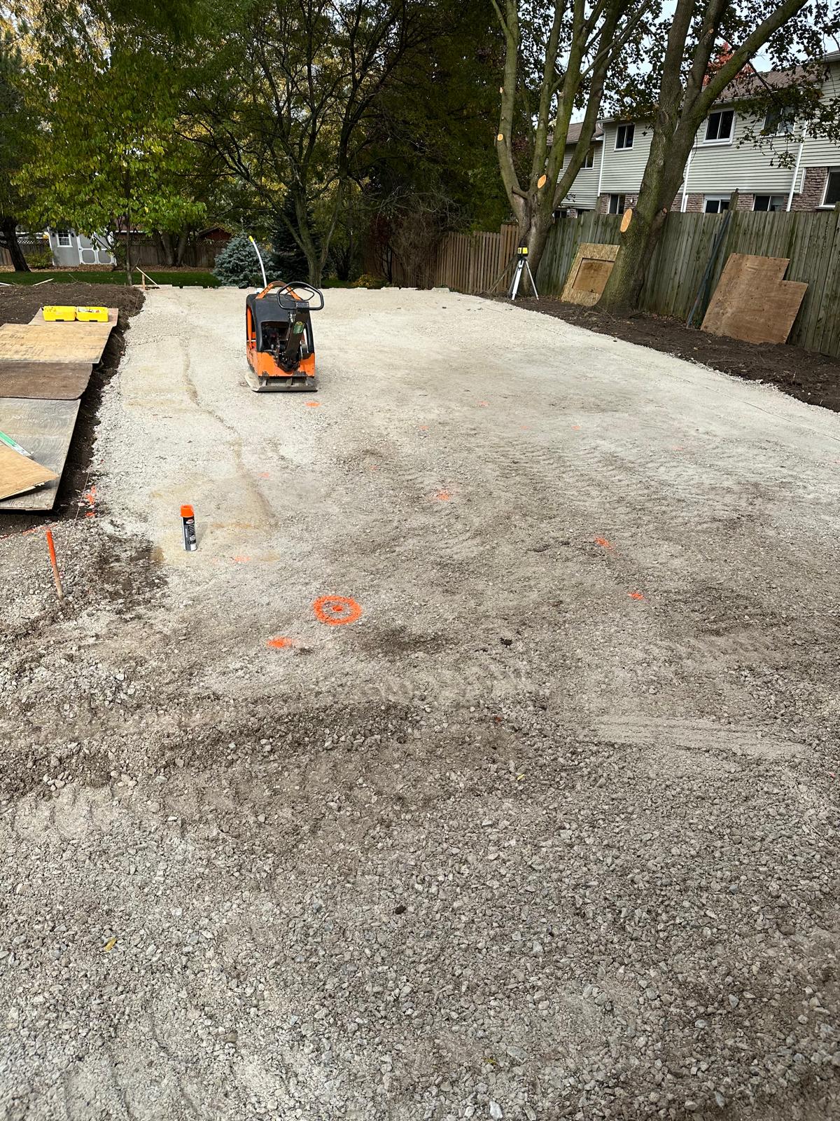 Building site being prepared and compacted with grade markers for SIP panel home foundation